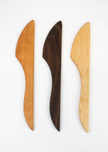 Three wooden knives on a white background