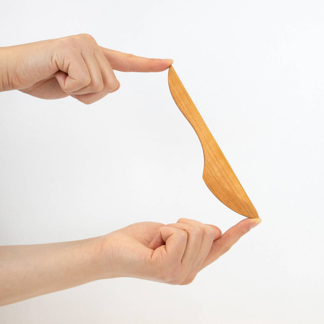Wooden knife on a white background