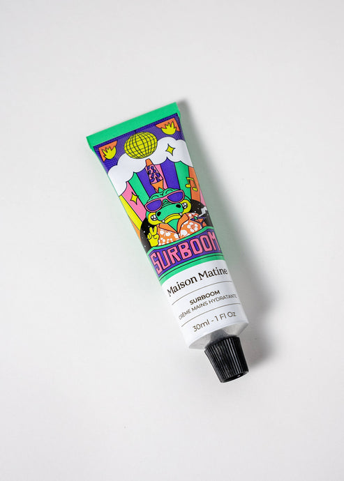 A tube of Surboom hand cream by Maison Matine, with a colorful and graphic design, placed against a white background.