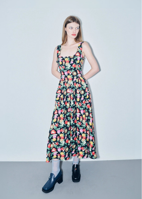 Woman wearing a floral dress on a plain background