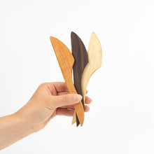 Three wooden knives on a white background